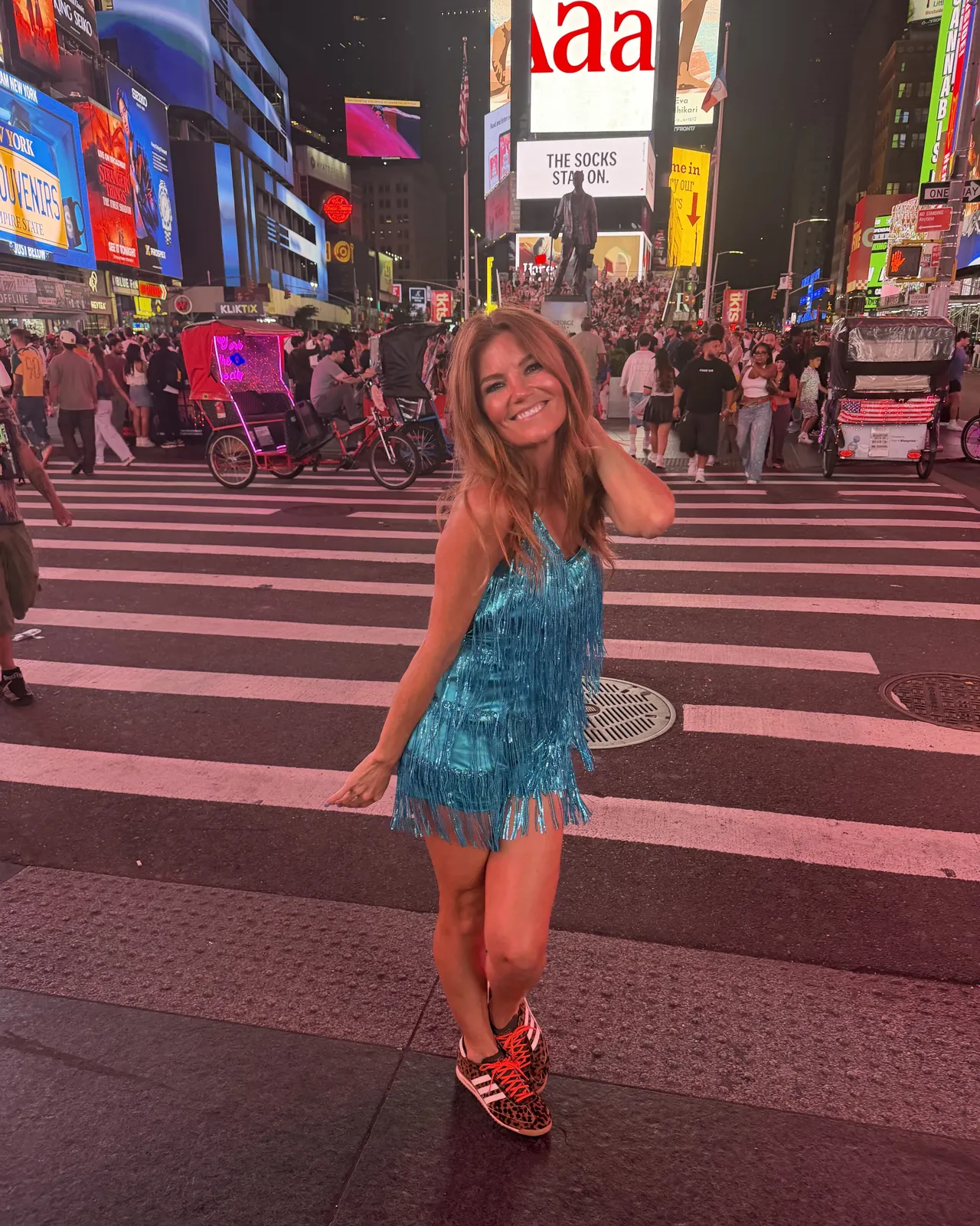 Kristin in a blue sparkly fringe dress in Times Square at night